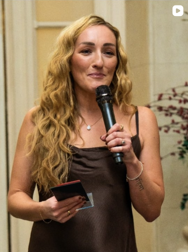 Host with microphone announcing an award winner